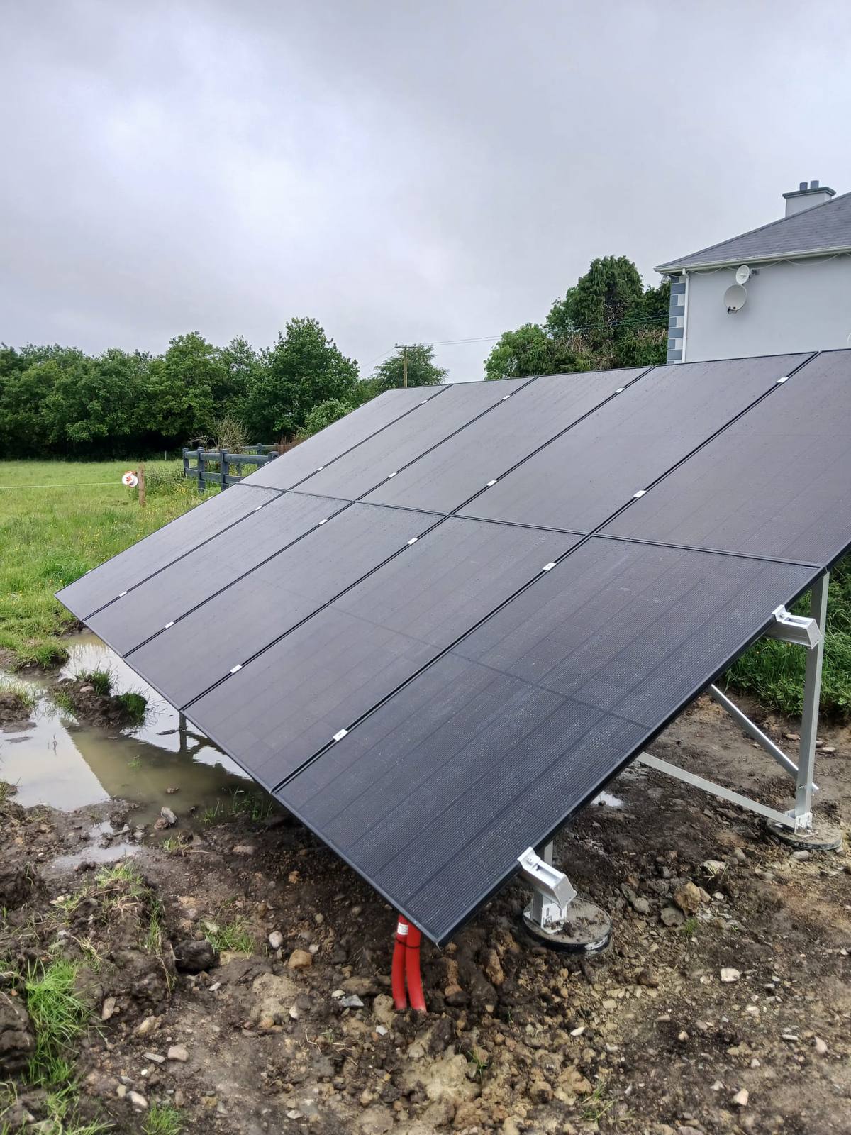 Ground-mounted solar array beside a home in the Cork countryside, installed by CTS Solar