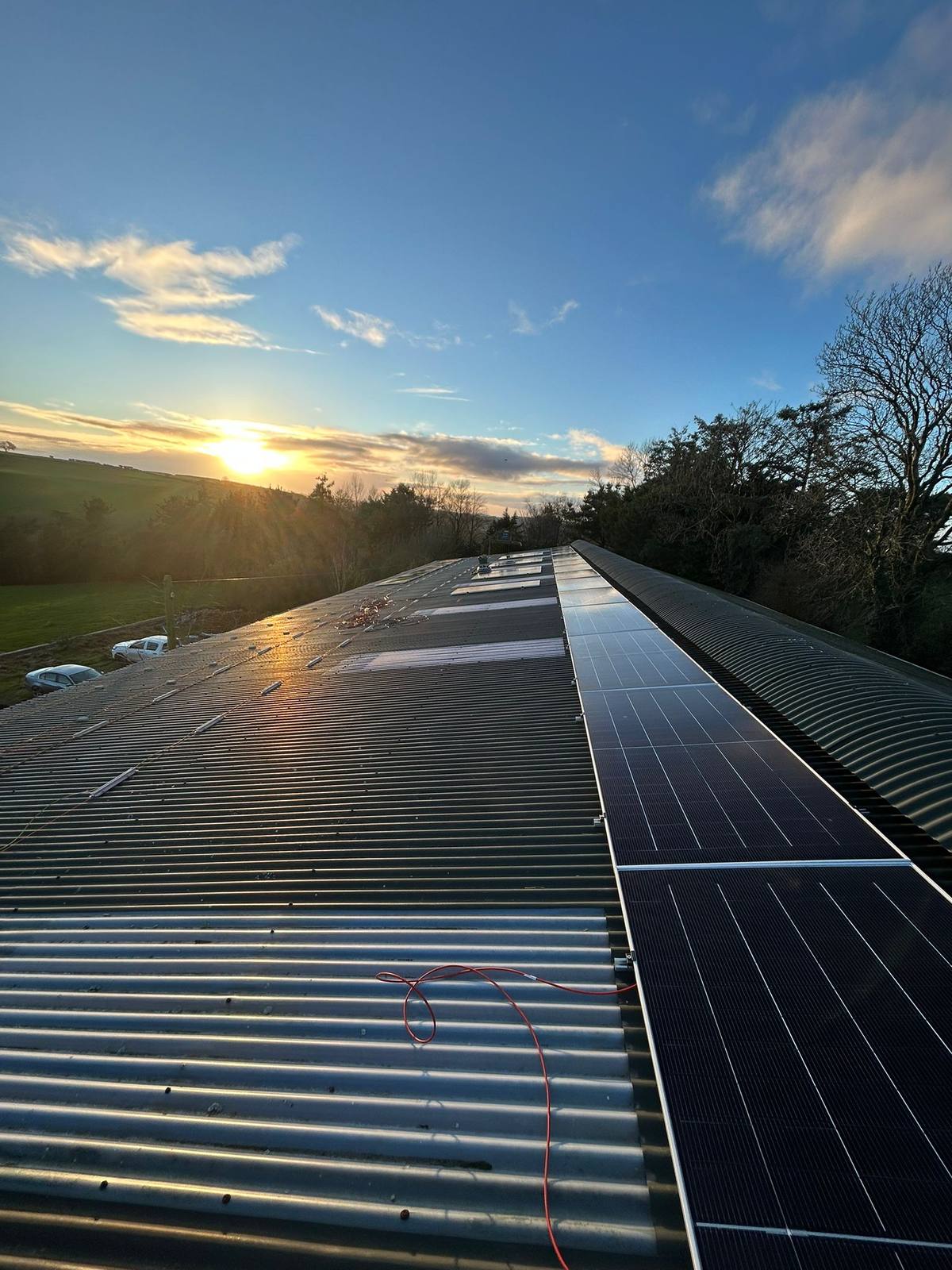 Solar panels along a rooftop at sunset on a Co. Cork install by CTS Solar